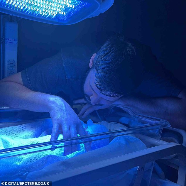 While another snap showed her son lying in a Babytherm as her boyfriend Scott looked after him.