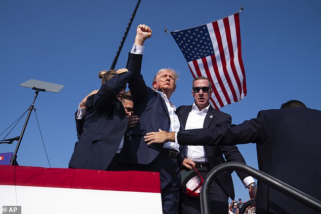 Republican presidential candidate former President Donald Trump is surrounded by U.S. Secret Service agents at a campaign rally, Saturday, July 13, 2024, in Butler, Pa.