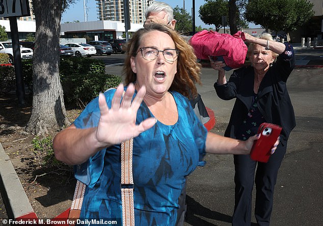 The doctor was accompanied by his daughter and his wife, who tried to block the cameras.