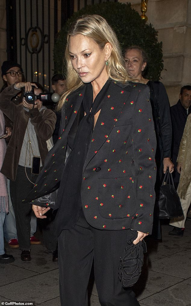 The model cut a chic figure in a fun printed blazer embroidered with strawberries as she headed to the French capital for another Fashion Week appearance.