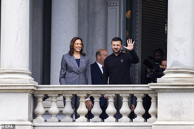 Vice President Kamala Harris and Ukrainian President Volodymyr Zelensky wave from the balcony of the Eisenhower Executive Office Building.