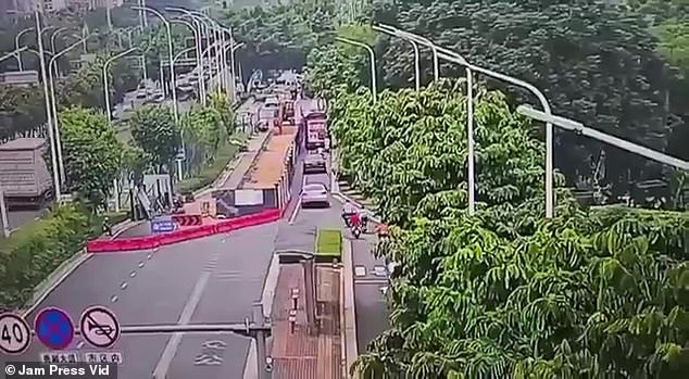 Cars were driving on a busy highway in the southern Chinese city of Nanning when the 'poo-cano' suddenly exploded, sending a huge cloud of brown dust into the sky.