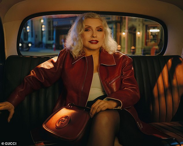 Photographer Nan Goldin also captured Debbie (born Angela Trimble) wearing an oxblood leather jacket selected by stylist Francesca Burns to pair with the $3,900 Gucci Blondie 'Small Top Handle Bag'.