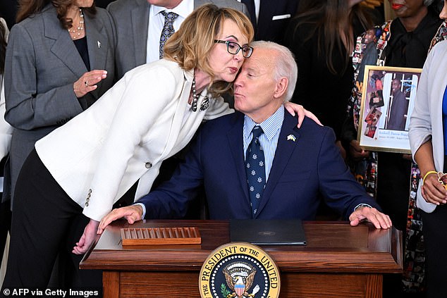 President Joe Biden (right) signs new executive orders related to gun control and hugs former Rep. Gabrielle Giffords (left), who survived an assassination attempt in 2011 in Tucson, Arizona.