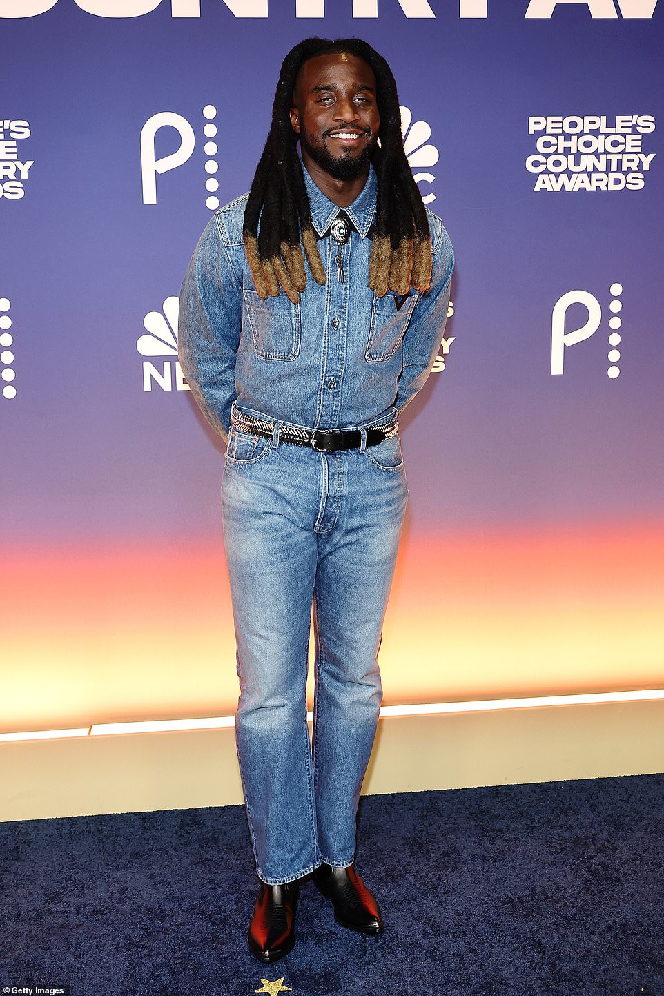 Shaboozey exuded confidence in a fun double denim look that consisted of a button-down shirt and classic blue jeans.