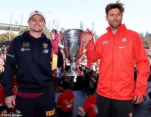 It follows Lachie Neale ensuring he keeps his hand on the premiership trophy a little longer than his opposite number Dane Rampe (pictured during Friday's Grand Final parade).