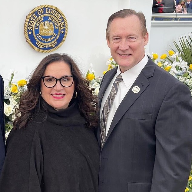 John Raymond with his wife Elizabeth posing in front of the Louisiana Seal