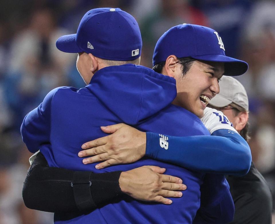 Shohei Ohtani, right, hugs teammate Walker Buehler after the Dodgers defeated the Padres.