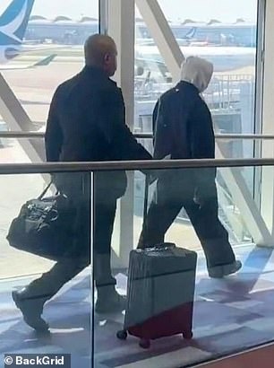 He walked through the airport alone in a rare appearance without his wife Bianca.