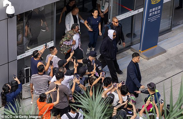 Security kept the crowd under control as they moved forward to take photos of the star.