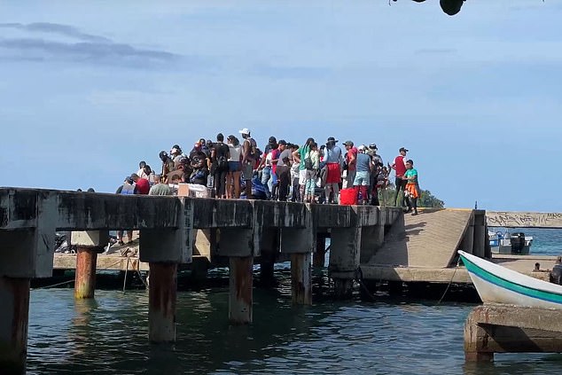 They are greeted at the docks (above) by infantrymen from the Gaitanista Self-Defense Forces of Colombia, a powerful paramilitary drug trafficking cartel that governs the region's smuggling routes.