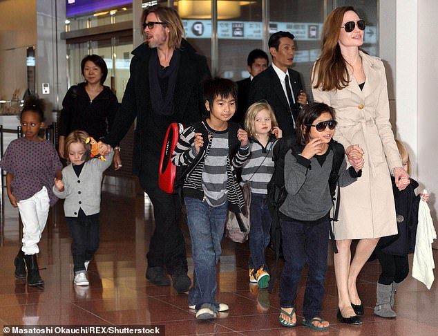 Jolie and Pitt are photographed with all their children at the Tokyo airport in 2011, five years before the divorce that sparked a rancorous custody battle.