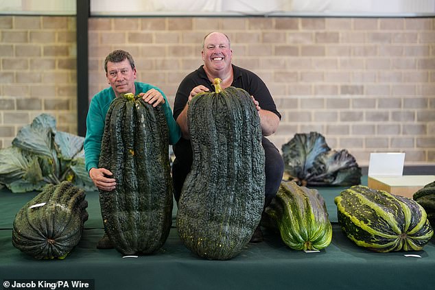 Two competitors pose with the giant pith they entered at the Malvern Autumn Show