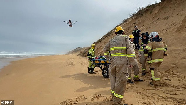 The man was found lying on the shore soaked by the waves when paramedics arrived at the scene shortly after 8am (pictured, a helicopter arrives at the scene)