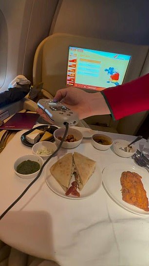 The businessman documented the ordeal on TikTok. In the photo, the flight attendant is trying to fix the entertainment system.