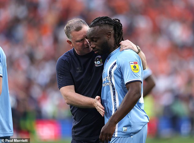 Coventry boss Robins consoles Dabo... but later that day told the player he would be released.