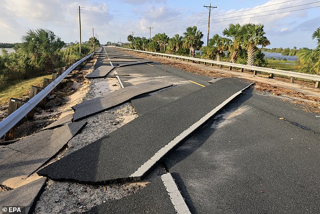 The powerful storm tore a highway from its foundation in Florida, where authorities urged residents to evacuate Thursday night.