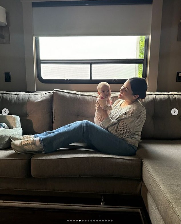 The mother of three looked happier than ever as she held her youngest son while sitting on the couch.