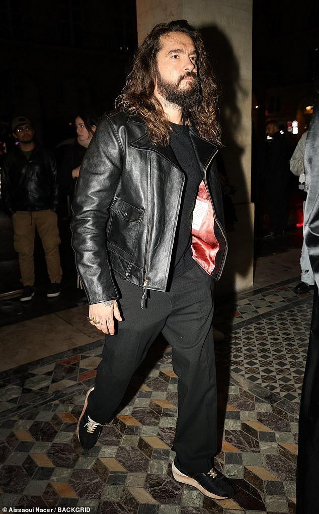 Tom wore a stylish black leather jacket and baggy pants which he paired with sneakers and a simple t-shirt.