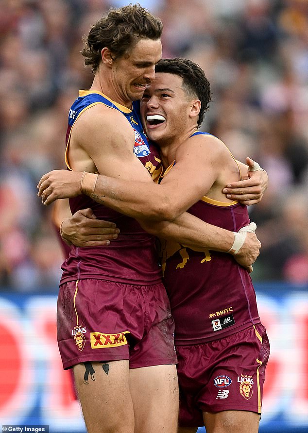 Lions teammates Joe Daniher and Cam Rayner celebrate a goal late in the final quarter with victory secured at the MCG.