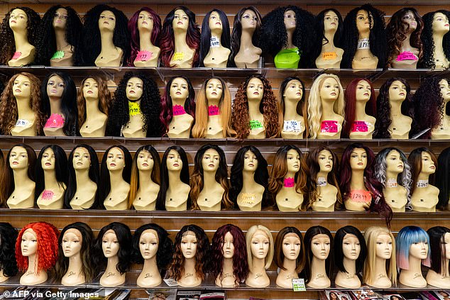 Although Lydia enjoys changing up her look with a variety of wigs, she said she is confident enough to leave the house without one. (Pictured: a wig shop in Peckham, south London)