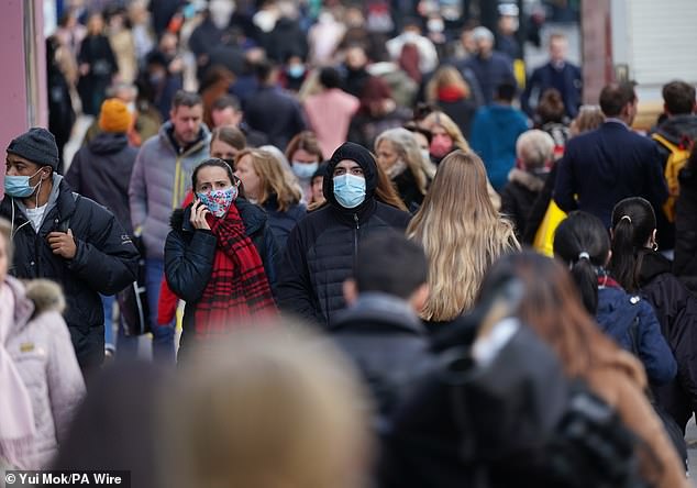 Lydia believes her alopecia could be caused by long Covid. It said it has suffered eight attacks of the virus since 2020. (Pictured: Shoppers wearing face masks on Oxford Street, London in 2021.)