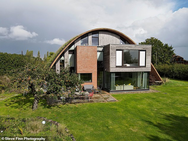 The arch of this unique house is less than 5 inches thick and is filled with gravel and soil on top to help stabilize the self-supporting frame.