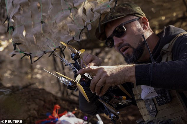 A Ukrainian soldier prepares a first-person view (FPV) drone to attack Russian troops in a position near the front line on September 25, 2024.