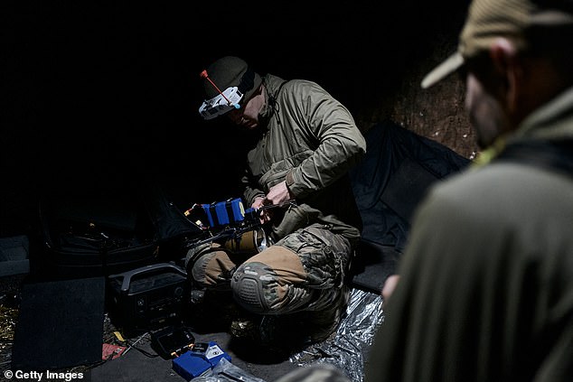 A Ukrainian military FPV drone pilot while placing an explosive on an FPV drone on the front line near Bakhmut on October 24, 2023 in Bakhmut, Ukraine.