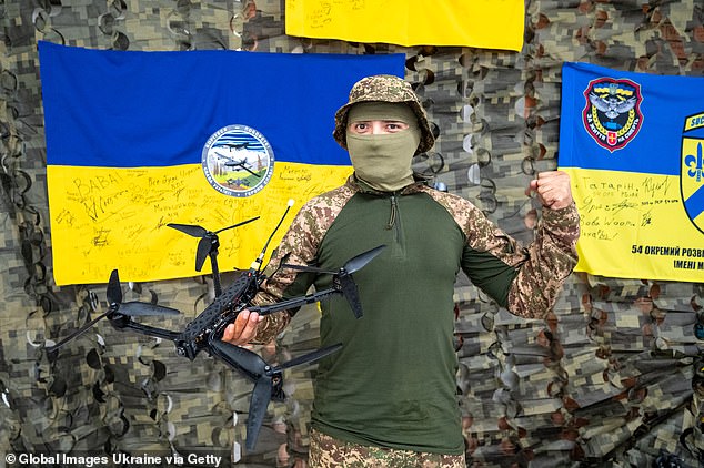 A Ukrainian Armed Forces soldier holds an FPV drone during a delivery to a volunteer organization on September 13, 2024.