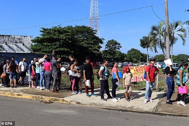 Migrants wait in line to resolve their status in the city of Tapachula, Mexico, September 23, 2024. Mexico's southern border is experiencing a new wave of migration as a month has passed since the new US rule allowing a Asylum appointment through 'CBP One' Application to be processed from the border of Mexico with Central America