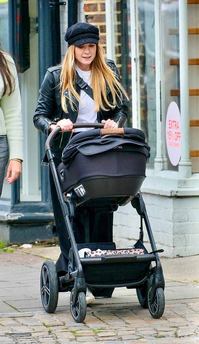 She was photographed pregnant for the first time in June while walking the red carpet at the Into Film Awards in London (pictured: pushing her newborn in Berkshire).