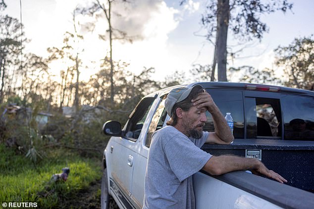 Matthew Harris leans on the bed of his truck after Hurricane Helene destroyed the home where he lived in Steinhatchee, Florida.