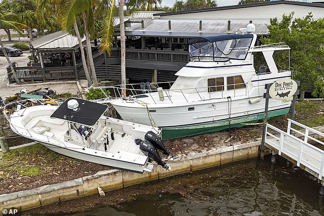 Wrecked boats washed ashore in St. Petersburg, Florida, seen Saturday morning