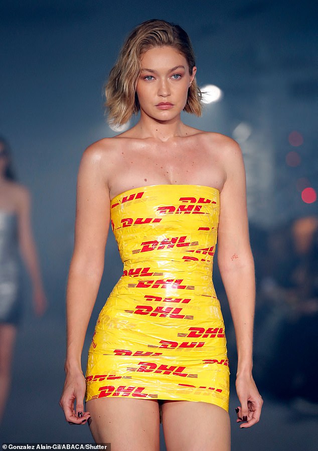 Elsewhere at Paris Fashion Week, Gigi Hadid showed she's got the package as a model, wearing a dress made from DHL tape at the Vetements show in Paris (pictured)