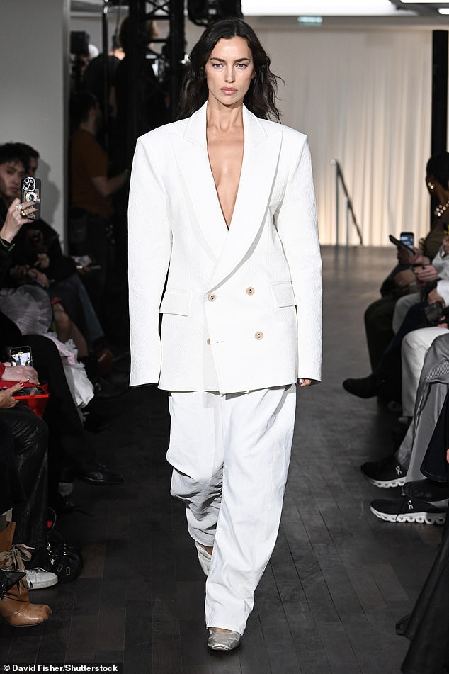 Attending the event, the rapper, 31, watched Irina Shayk strut down the runway while modeling the luxury brand's Spring Summer 2025 collection.