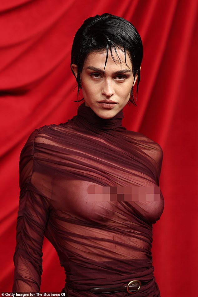 Meanwhile, Amelia dared to strip braless at the fashion event, revealing her bare breasts beneath a sheer burgundy dress.