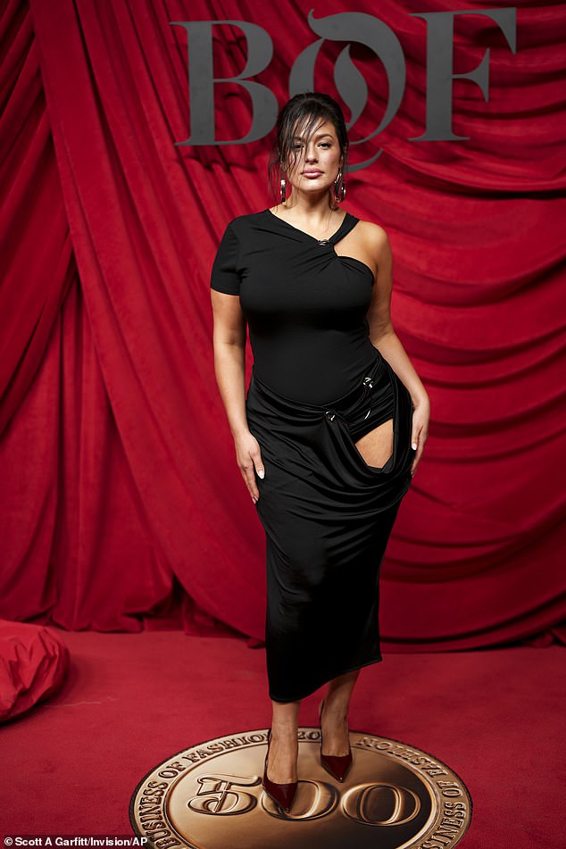 Meanwhile, Ashely turned up the heat as she modeled a black off-the-shoulder midi dress that featured a cutout panel that revealed a glimpse of her leg.