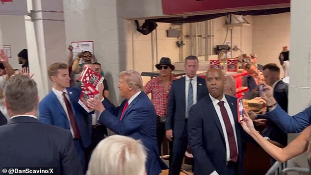 Trump greets attendees at the Alabama-Georgia game as he himself enters the venue