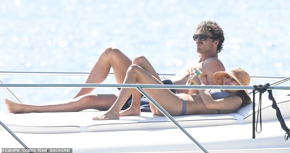 When they weren't taking a dip, the couple enjoyed the warm weather while lounging on a deck area towards the front of the yacht.