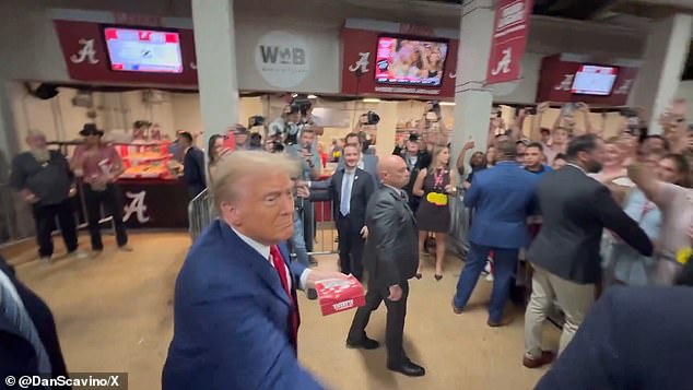 Former President Donald Trump throws food at fans behind stadium barricades