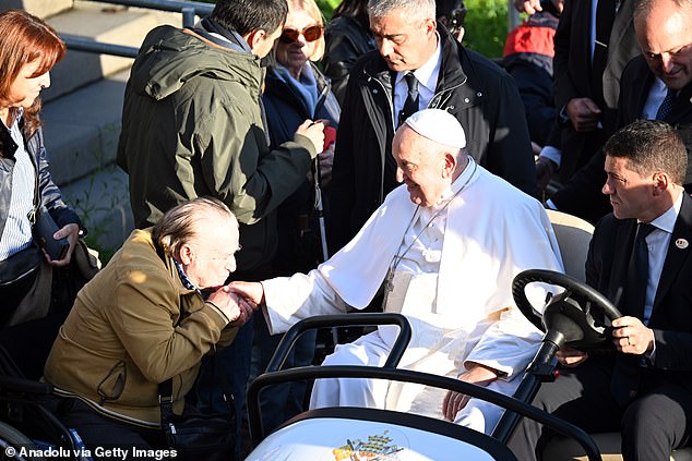 Pope Francis greets the public as he meets with students and members of the Catholic University of Leuven during his three-day visit to Leuven-la-Neuve, Belgium.