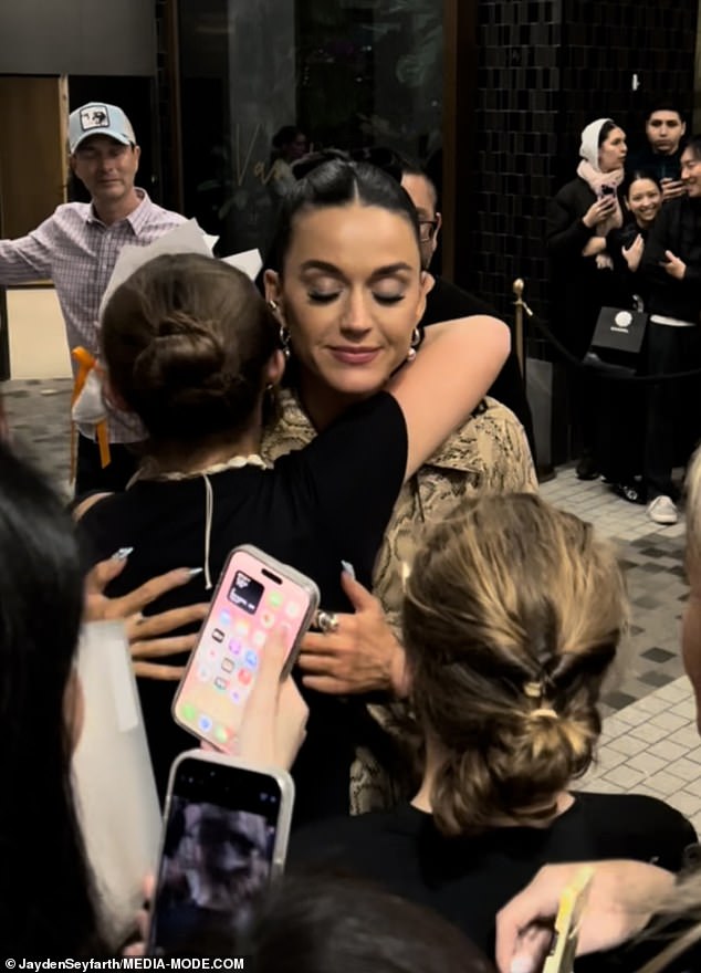 The I Kissed A Girl singer was seen sweetly hugging a young fan during a sweet moment as crowds gathered outside her hotel.