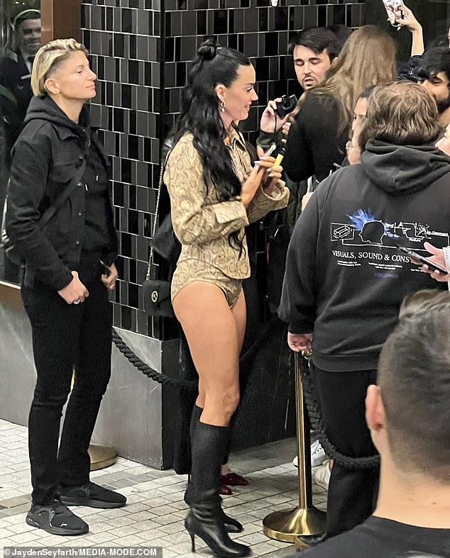 Katy put on a leggy display in leopard print shorts and a matching collared top as she greeted her delighted fans outside the hotel.