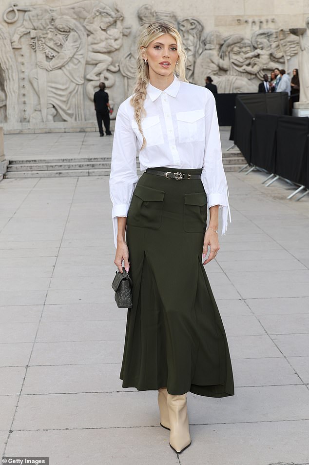 She paired her look with a small black designer bag and a thin belt that cinched her waist.