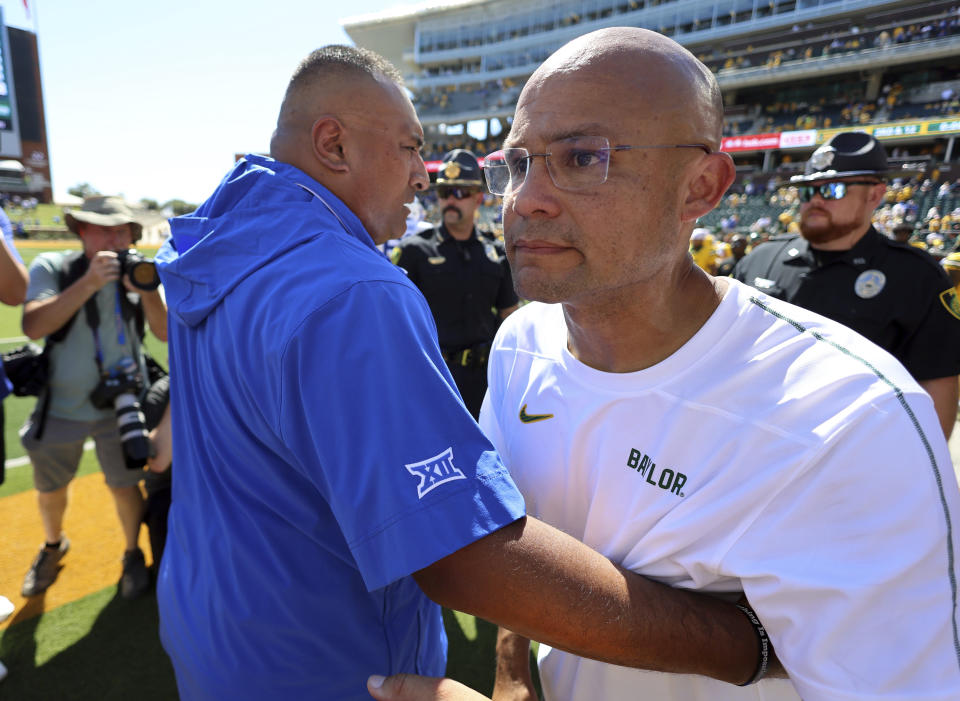 BYU head coach Kalani Sitake, left, hugs Baylor head coach Dave Aranda after an NCAA college football game on Saturday, Sept. 28, 2024, in Waco, Texas. (AP Photo/Richard W. Rodriguez)