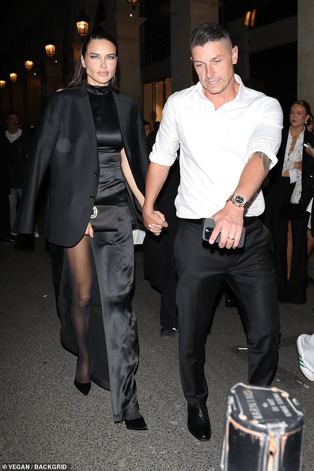 Adriana looked elegant in a black satin dress as she left the party hand in hand with her partner Andre.