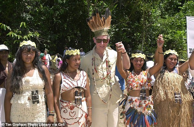 Pictured: Prince Charles in Guyana, South America, wearing garlands and a feather and palm leaf headdress.