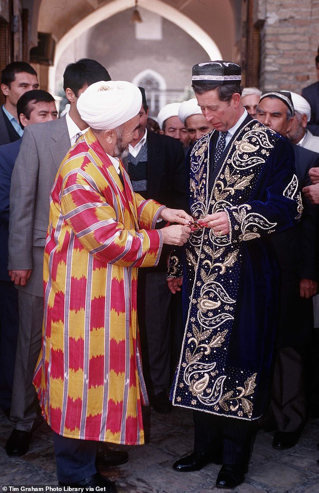 Pictured: Prince Charles receives a traditional gold-embroidered blue velvet wedding suit during a trip to Tashkent, the capital of Uzbekistan, in 1996.