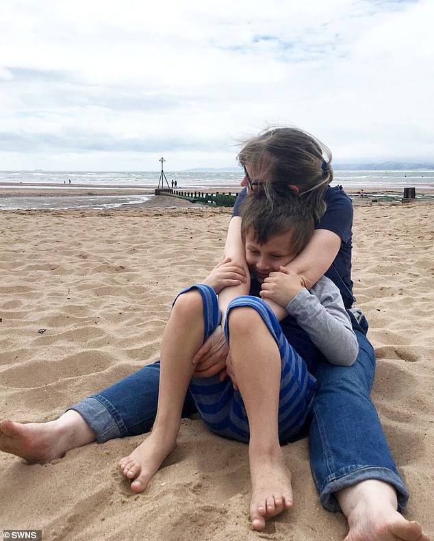 Beth pictured enjoying a cuddle with her eldest son, William, on the beach.